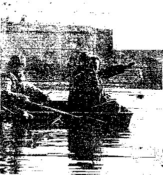 ENDING THE SUSPENSE - Searchers hold the lantern after it was pulled from the pond behind Carbondale's Russel Park Monday afternoon. Holding the light is Jerome Gillott. Others in the boat are Carbondale Patrolmen Mark Trella, left, and John Barbaro.